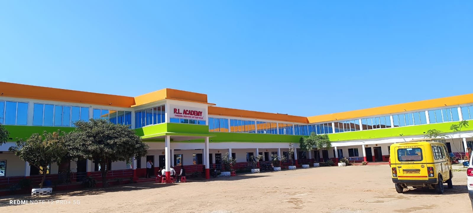 R.L. Academy building with school bus and playground